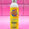 A bottle of lotion on a pink tile background