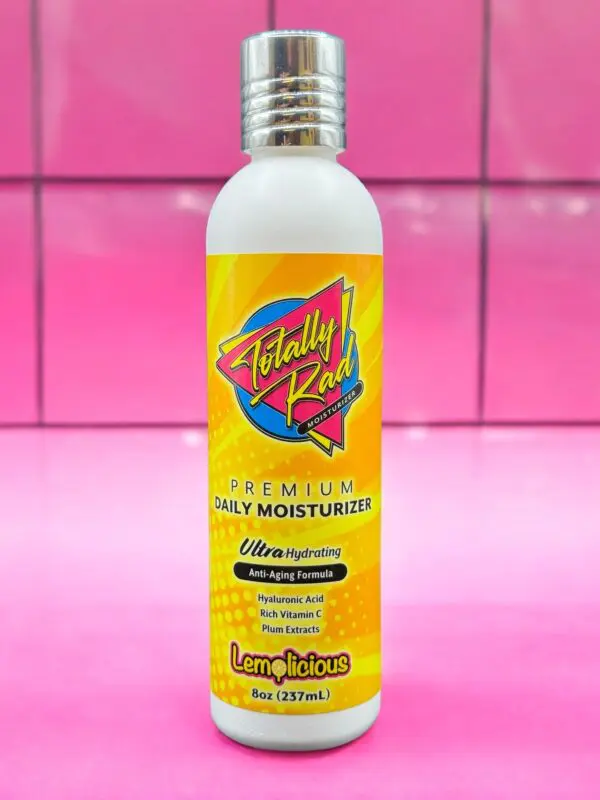 A bottle of lotion on a pink tile background